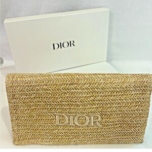 Christian Dior straw/raffia woven cosmetic pouch.